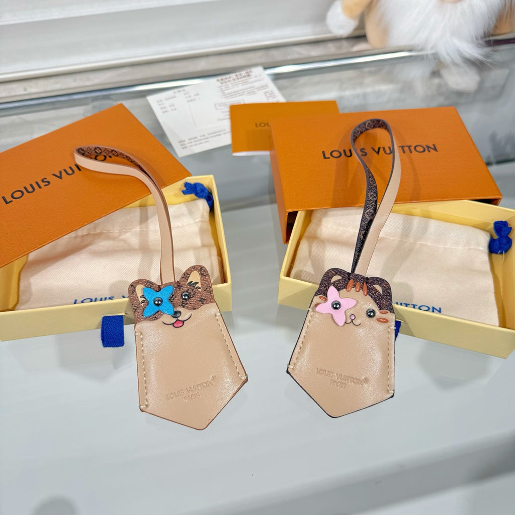 Pair of beige keychain accessories with cartoon animal face charms