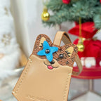 Louis Vuitton beige key pouch with blue cat face patch and cartoon whiskers charm