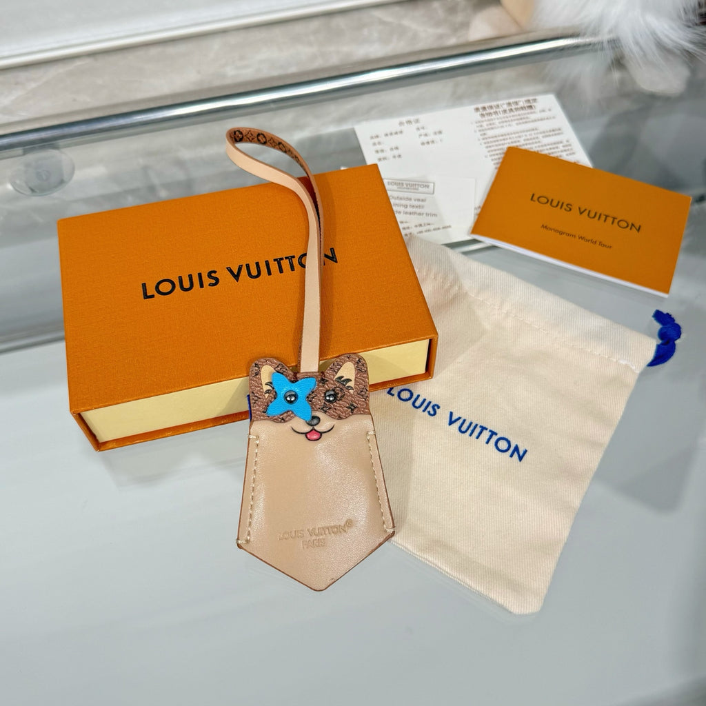 Louis Vuitton beige key pouch with blue cat face charm and leather wrist strap