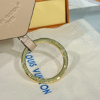 Louis Vuitton beige key pouch with gold key ring and blue printed letters on cloth