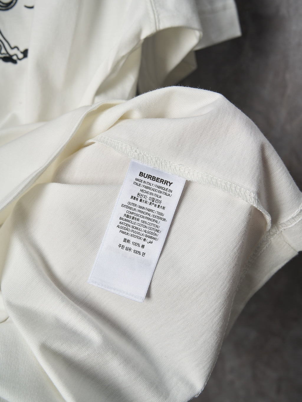 White T-shirt with fabric care label inside near neckline