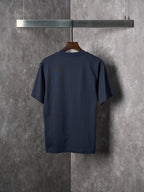 Navy crew-neck short-sleeve T-shirt shown from the back on a wooden hanger