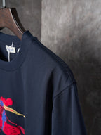 Navy short-sleeve T-shirt with side seam and visible colorful front graphic
