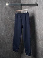 Navy jogger pants with straight legs and elastic cuffs