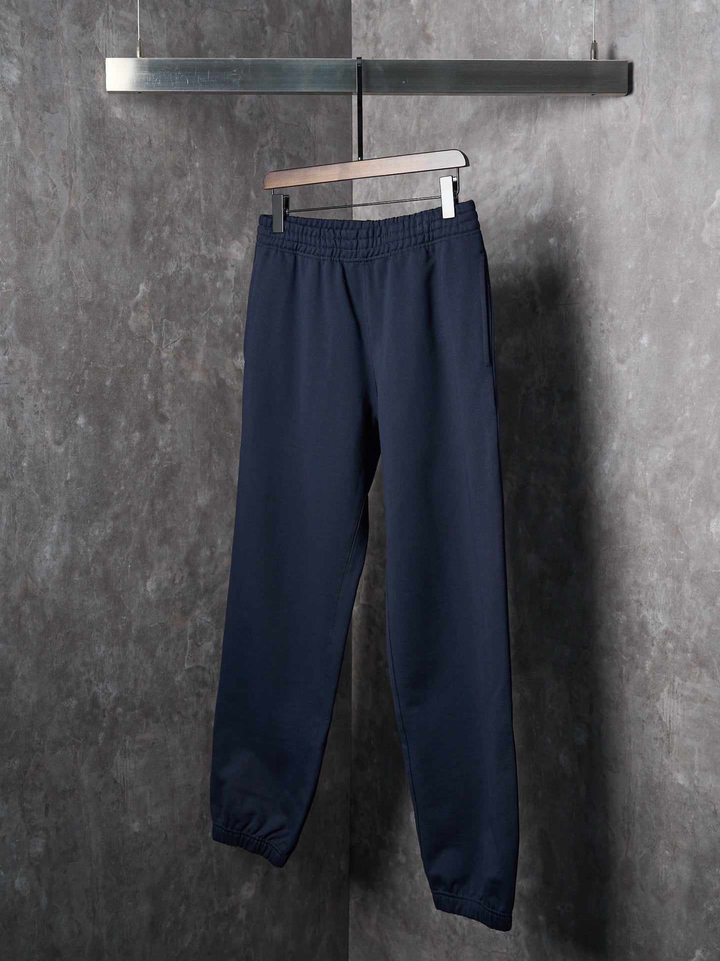 Navy jogger pants with straight legs and elastic cuffs