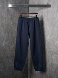 Navy jogger pants with elastic waistband and elastic cuffs