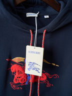 Navy hoodie with Burberry neck label and red drawstrings over chest graphic