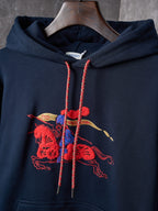 Navy hoodie hood with red drawstrings and colorful embroidered emblem