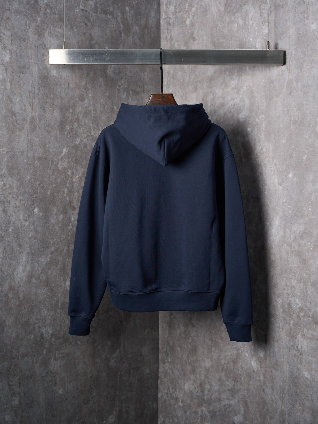 Navy pullover hoodie with attached hood and long sleeves