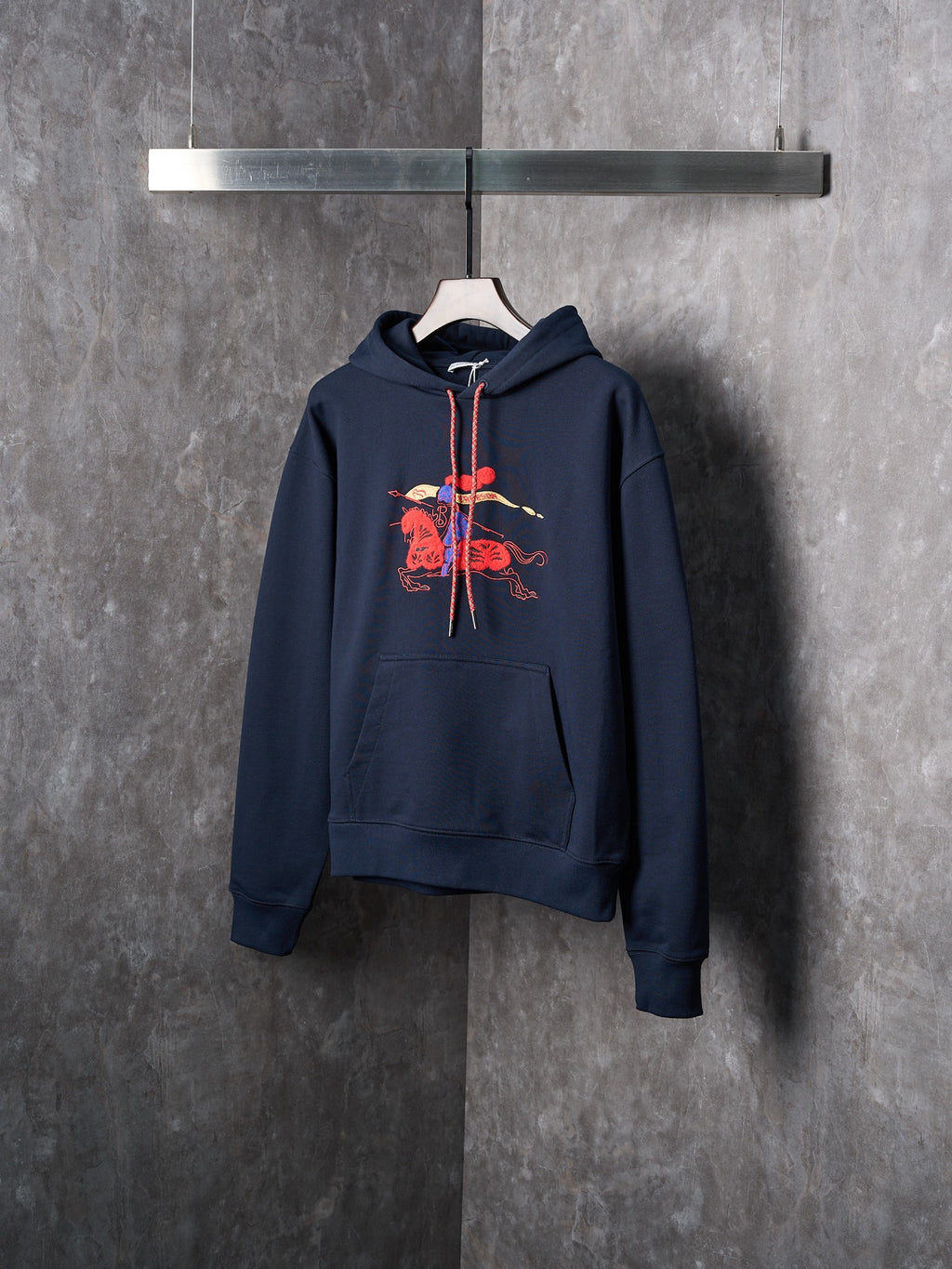 Navy pullover hoodie with chest embroidered graphic and drawstring hood