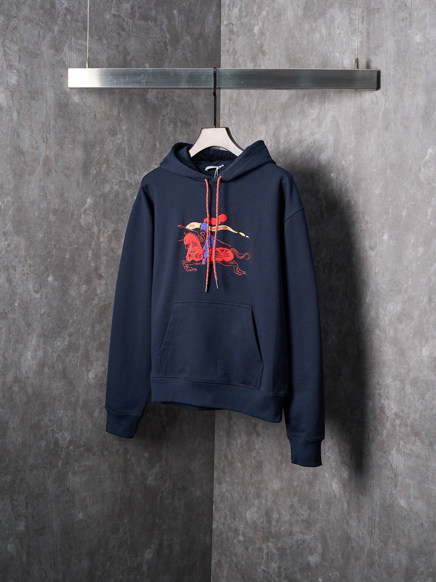 Navy pullover hoodie with chest embroidered graphic and drawstring hood