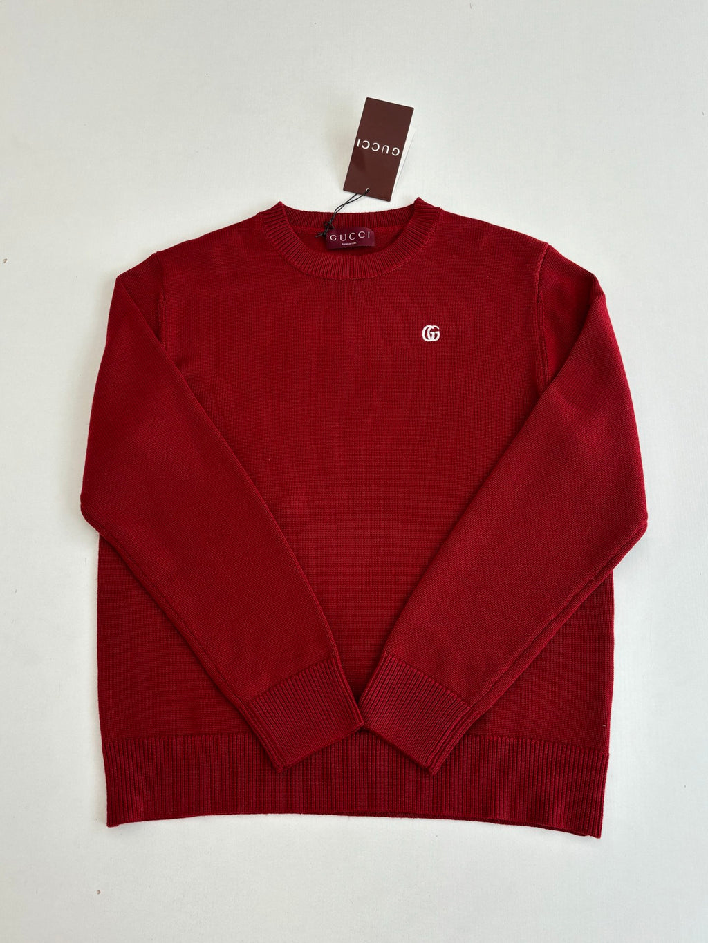 Red Gucci crewneck sweater with small GG logo on the chest