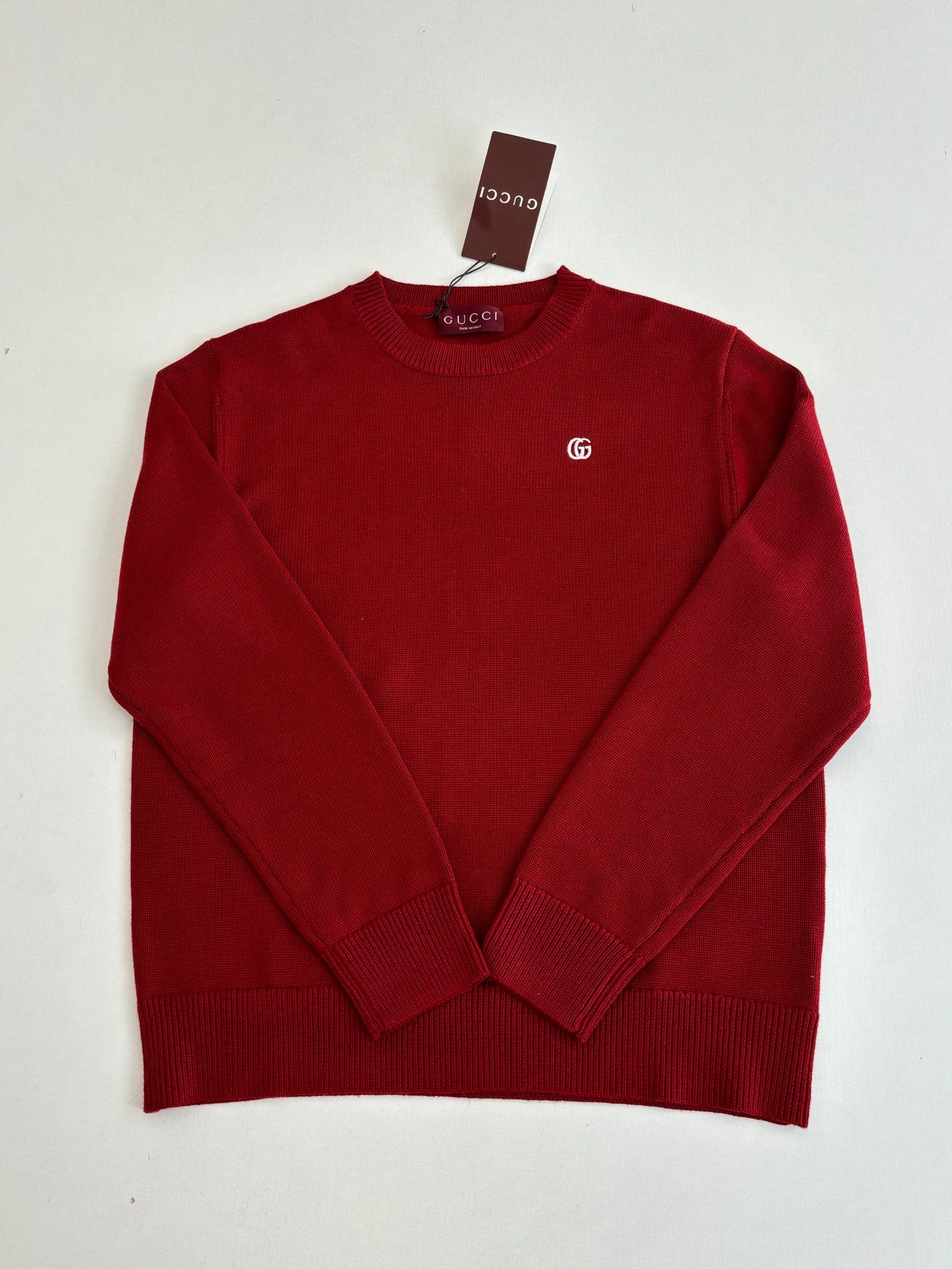 Red Gucci crewneck sweater with small GG logo on the chest