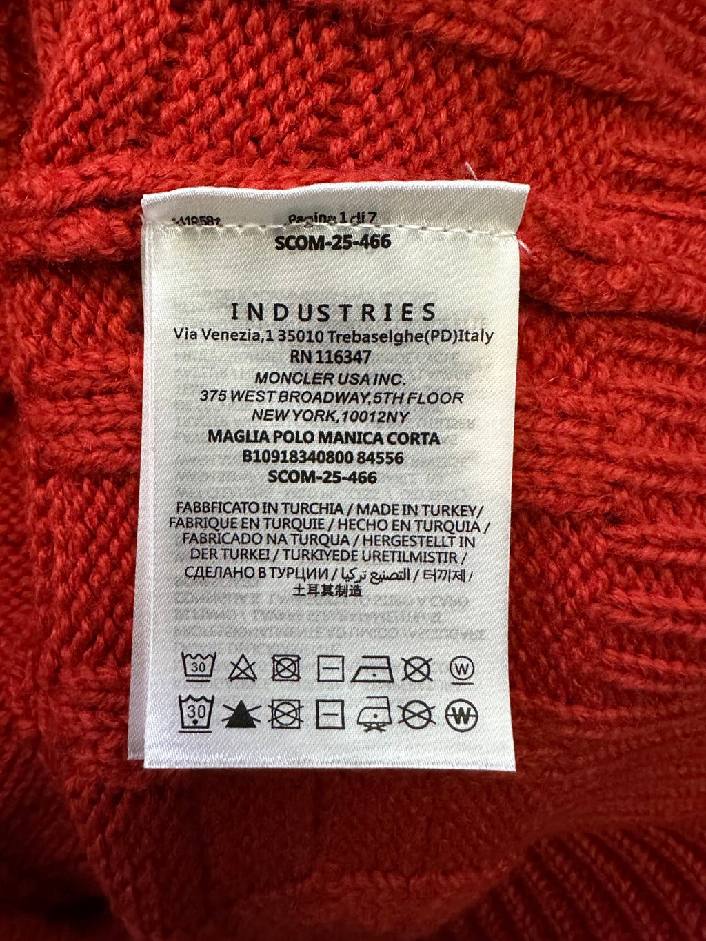 Inside neck label on red knit sweater with Industries brand and care symbols