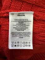 Inside neck label on red knit sweater with Industries brand and care symbols