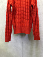 Red long-sleeve knit sweater back view with ribbed cuffs and hem