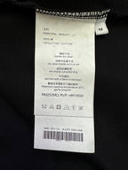 Black T-shirt care label with size M and fabric/care instructions