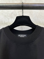 Black crew-neck T-shirt with BALENCIAGA neck label and ribbed collar