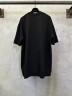 Black T-shirt on hanger, back view with short sleeves and crew neckline