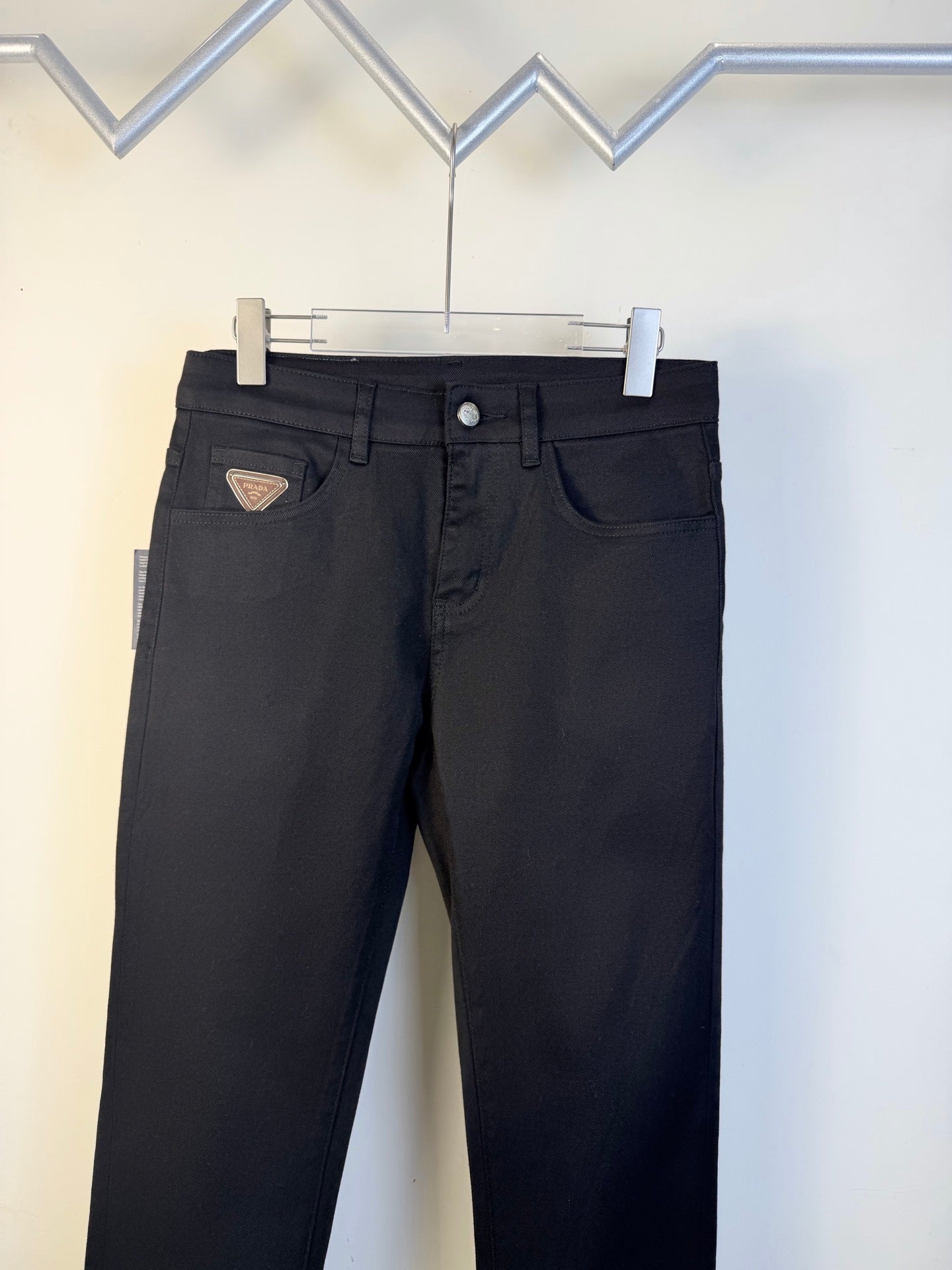 Prada dark blue pants with button fly and front pockets on hanger