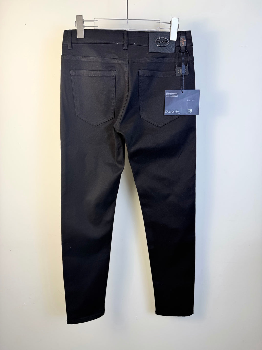 Prada dark blue pants on hanger with front pockets and hanging tags