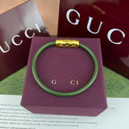 Gucci elastic bracelet in olive green with gold-tone logo bar clasp