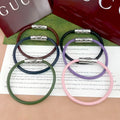 Gucci braided bracelets with logo bar clasp in dark green, navy, lavender, and pink