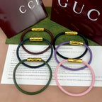 Gucci braided bracelets with logo bar clasp in green, navy, lavender, and pink (gold-tone)