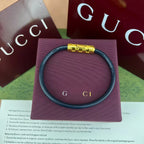 Gucci elastic bracelet in dark teal with gold-tone logo bar clasp