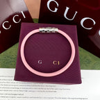 Gucci elastic bracelet in light pink with silver-tone logo bar clasp