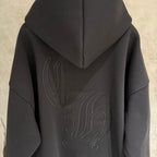 Dark hoodie back close-up with hood and raised embroidered graphic