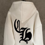 White hoodie back with large black emblem and hood