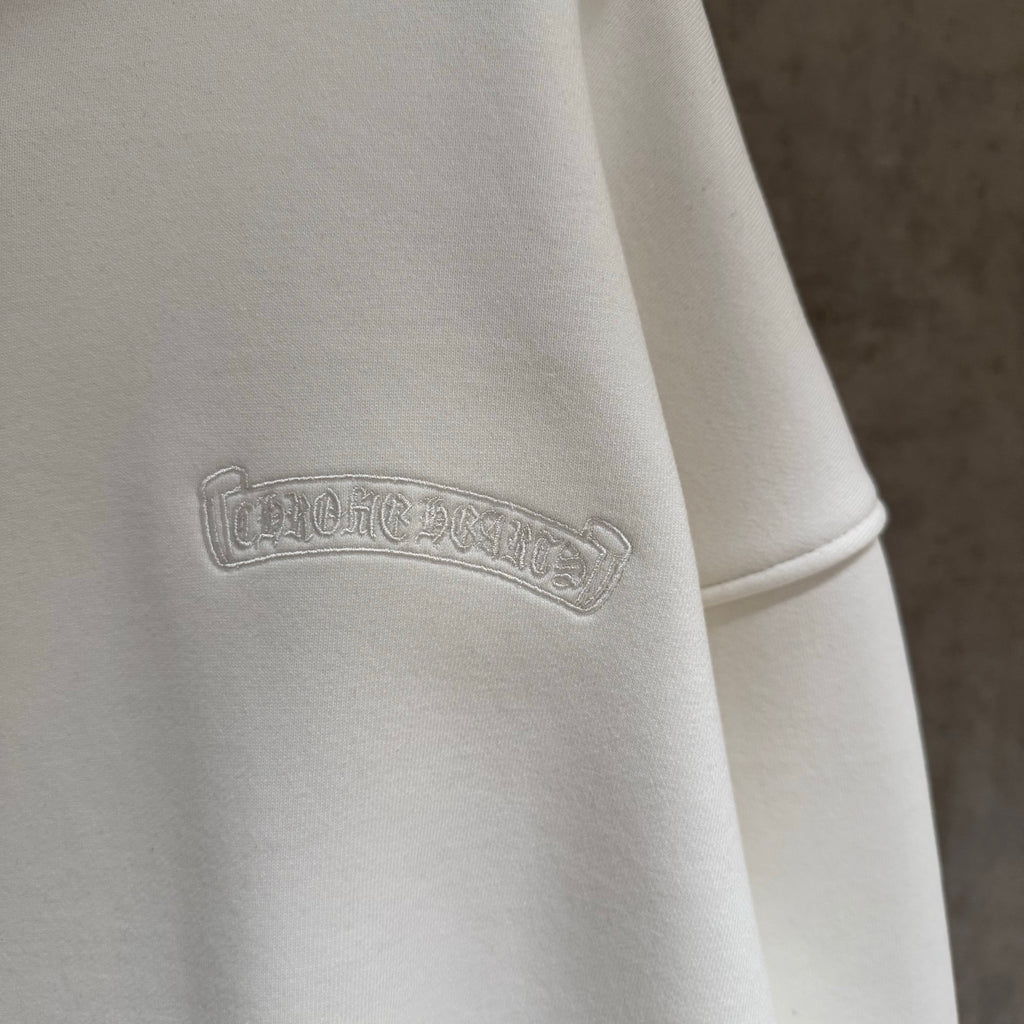 White hoodie with embossed logo on upper sleeve