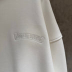 White hoodie with embossed logo on upper sleeve
