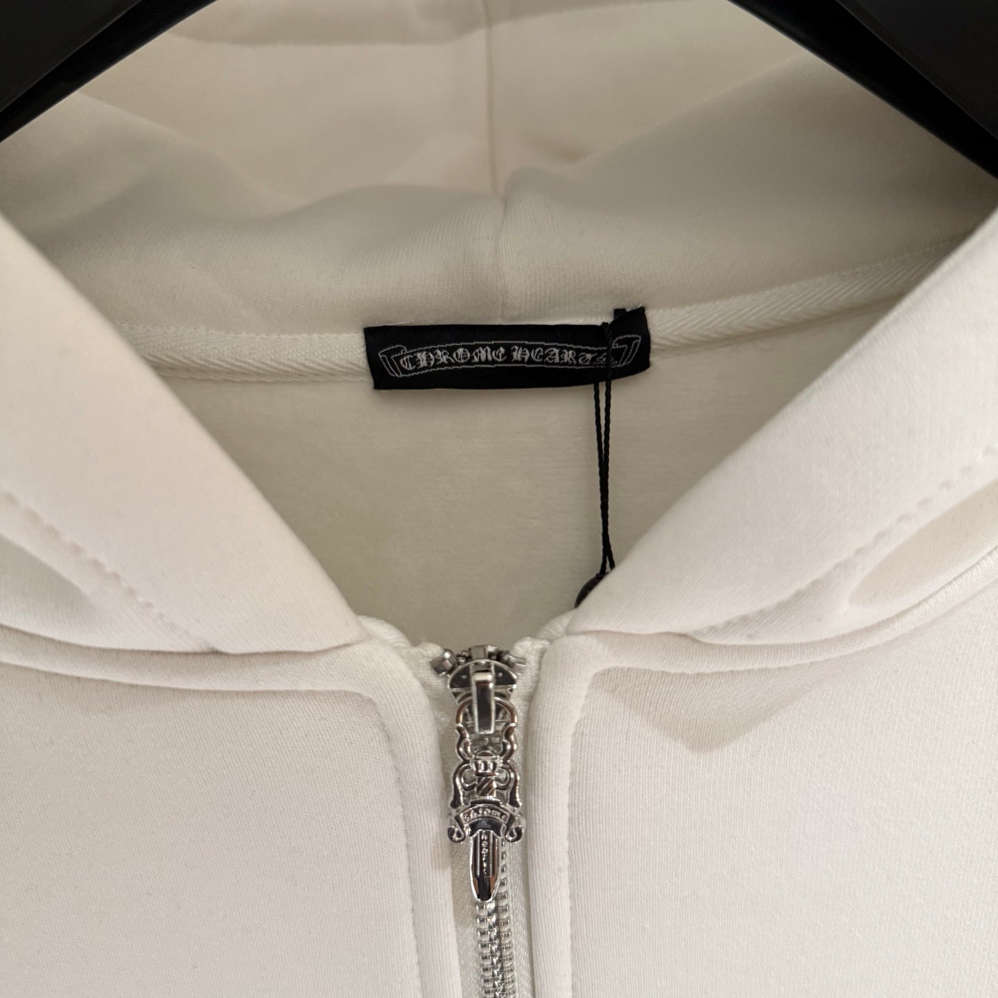 White hoodie lining with neck label and metal zipper pull