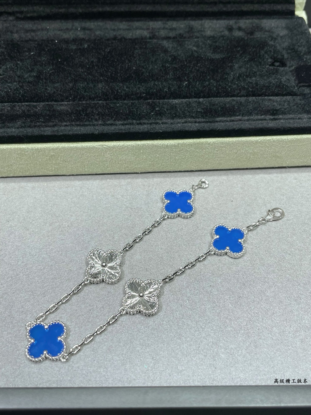 Van Cleef & Arpels close-up clover bracelet with blue enamel charms on silver chain