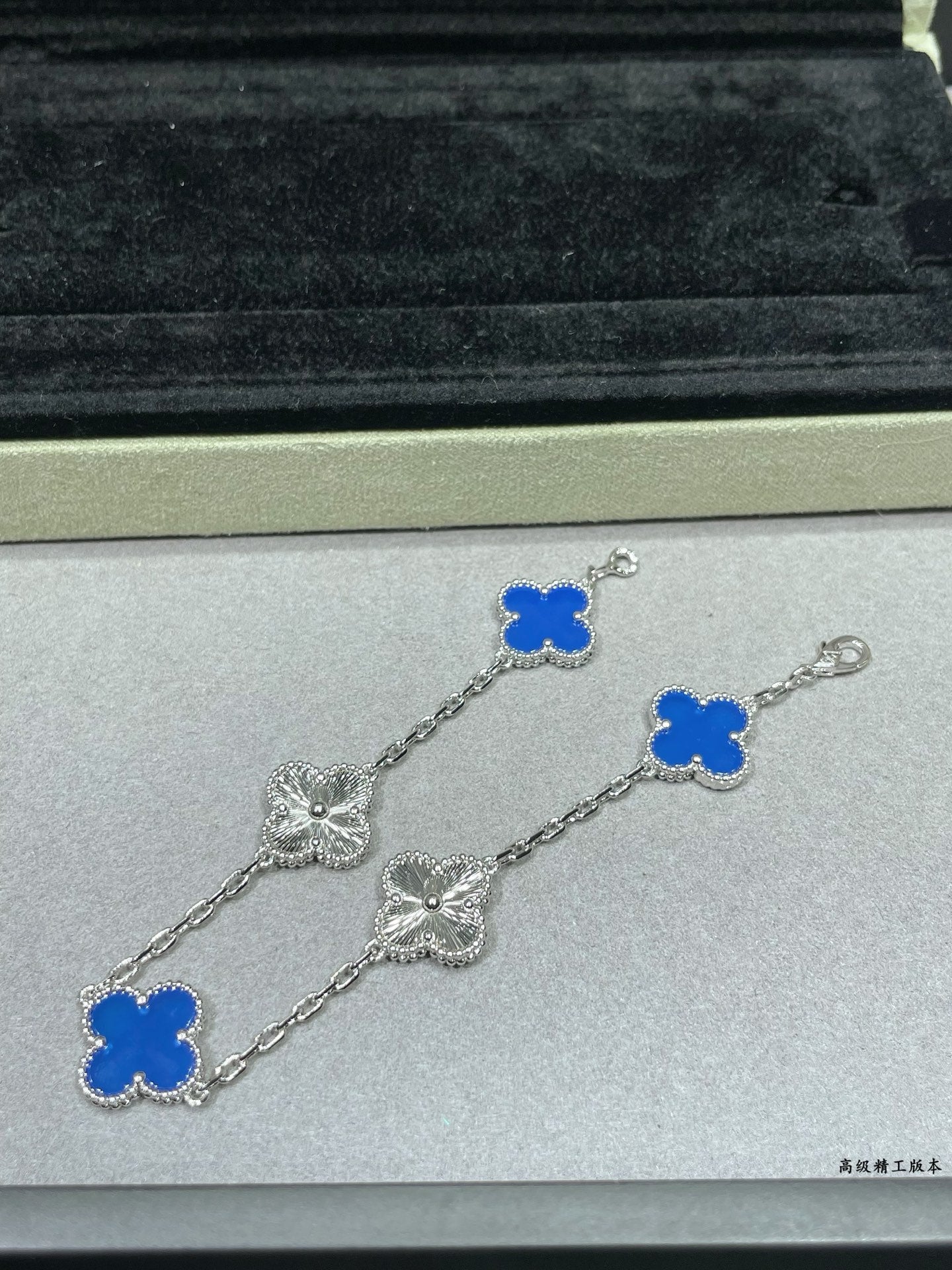 Van Cleef & Arpels close-up clover bracelet with blue enamel charms on silver chain