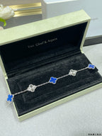 Van Cleef & Arpels clover bracelet with blue enamel motifs on silver-toned chain in box