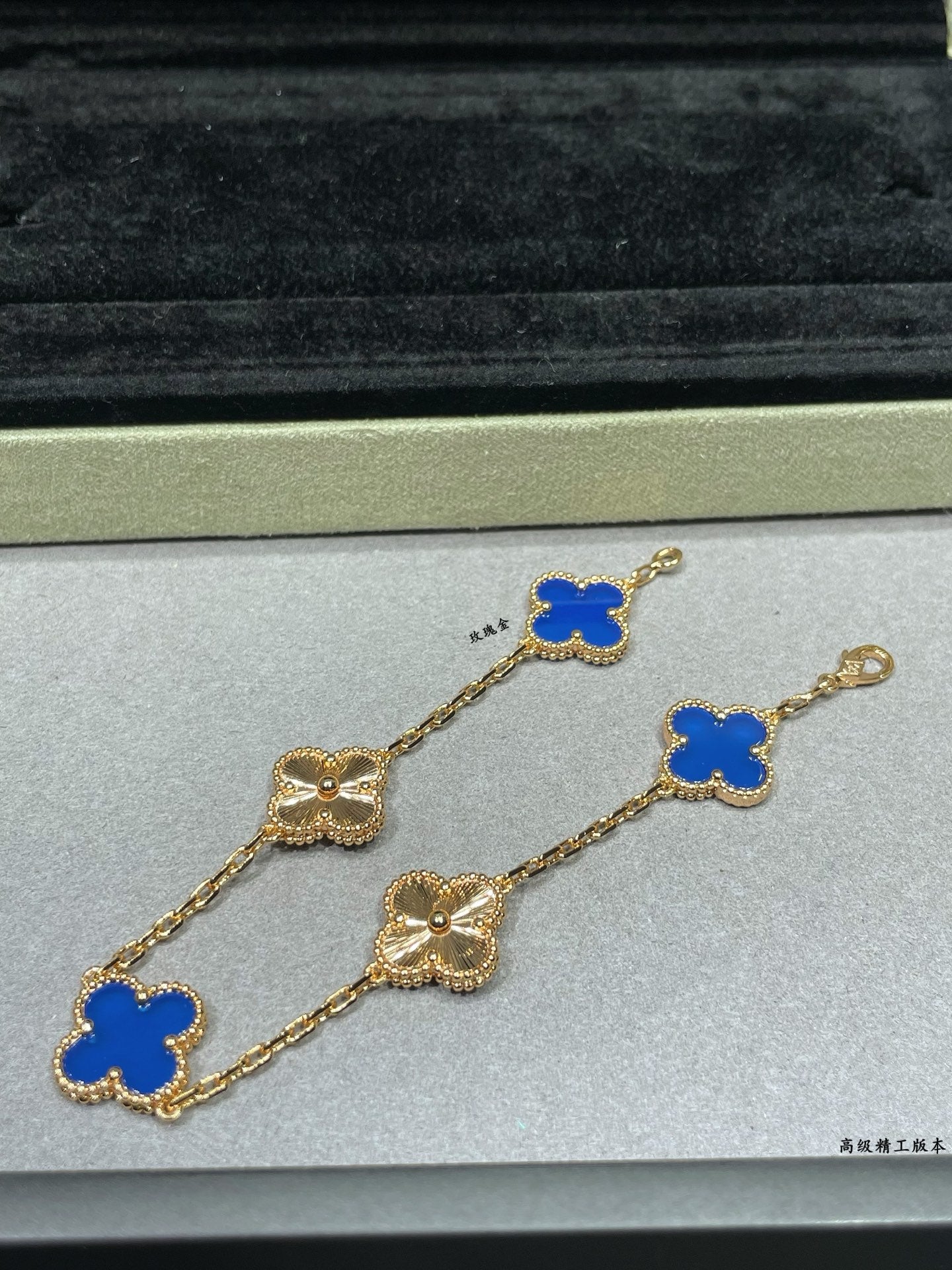 Van Cleef & Arpels close-up clover bracelet with blue enamel charms on gold chain