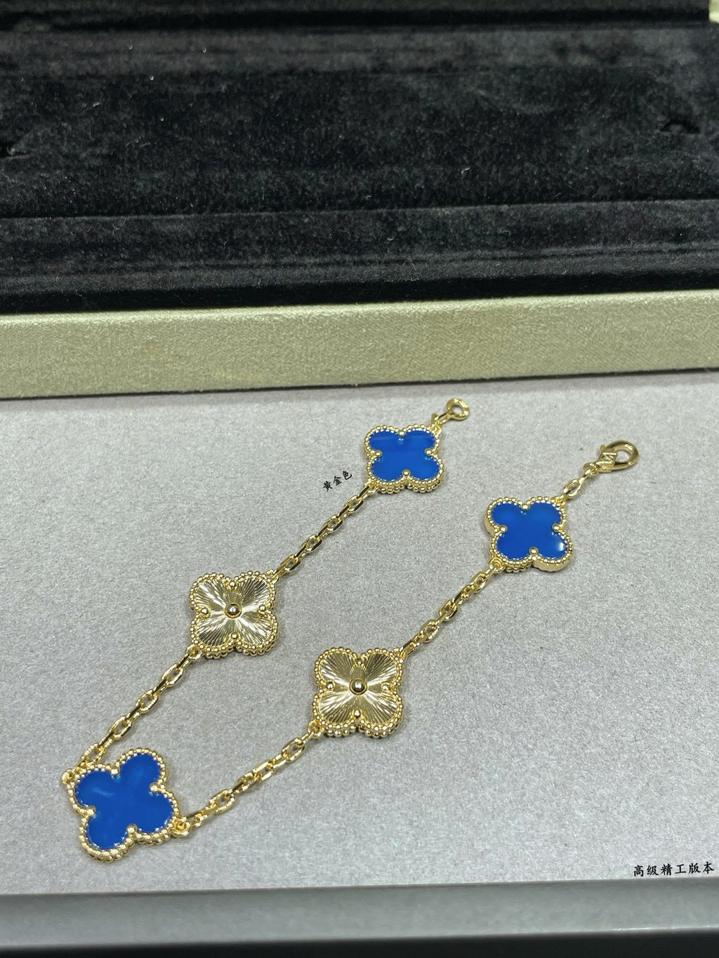 Van Cleef & Arpels clover bracelet close-up with blue enamel charms on gold chain