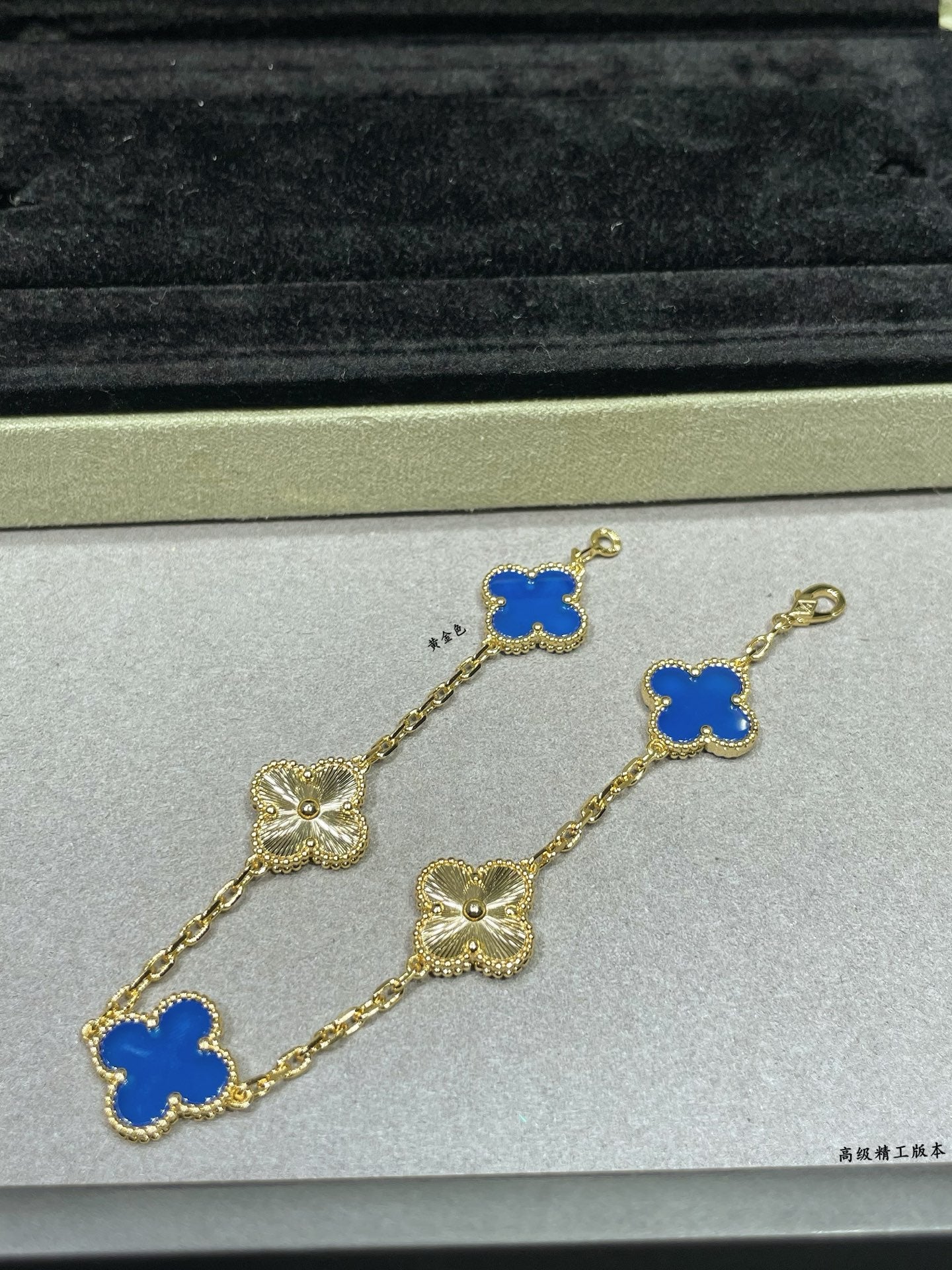 Van Cleef & Arpels clover bracelet close-up with blue enamel charms on gold chain