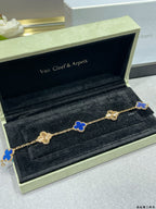 Van Cleef & Arpels clover bracelet with blue enamel motifs on gold chain in jewelry box