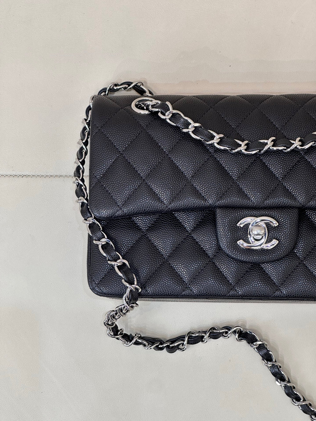 Chanel quilted shoulder bag close-up, chain strap and CC logo on flap