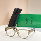 Light gold eyeglasses with clear frame panels and gold logo accents