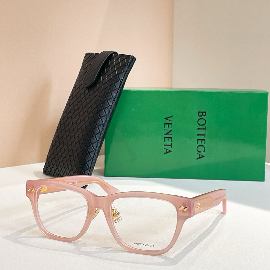 Pink eyeglasses with gold logo details and square frame silhouette