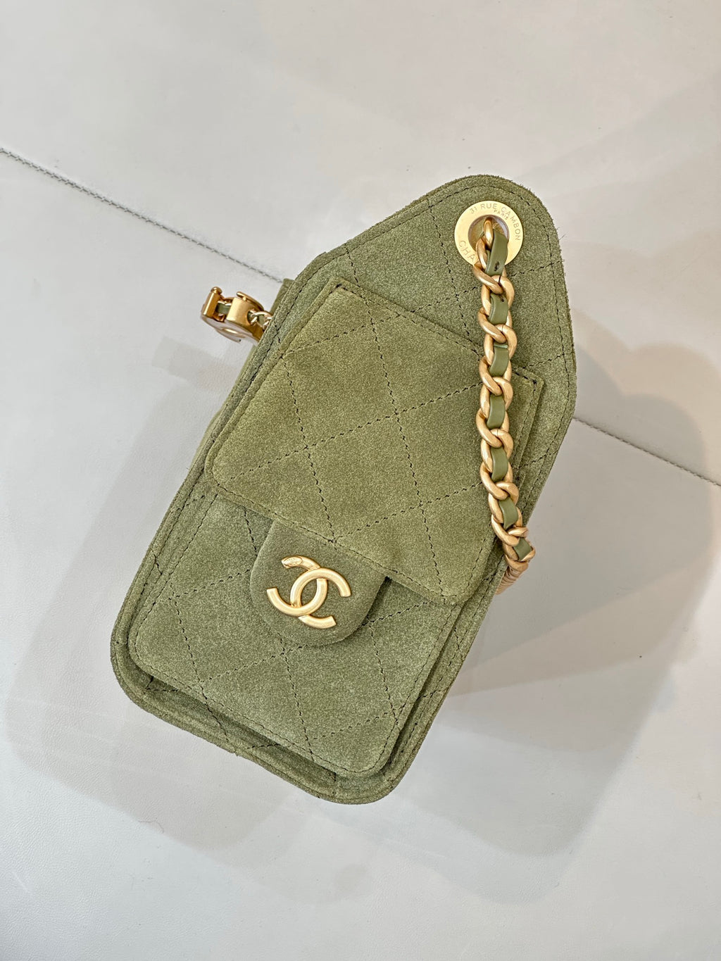 Chanel mini bag in olive green with gold chain and front flap with CC emblem