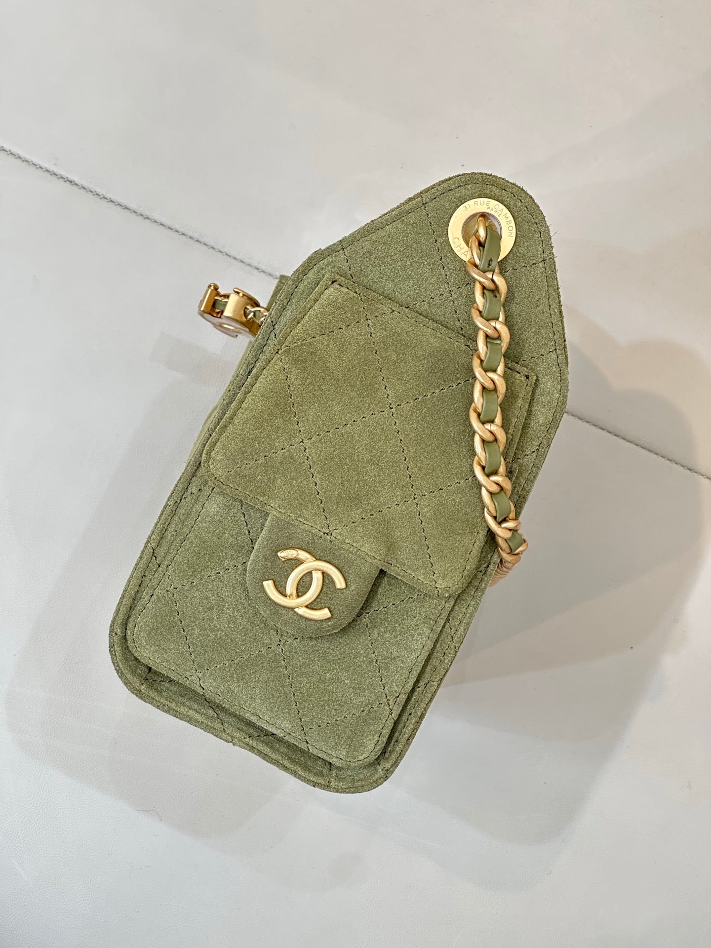 Chanel mini bag in olive green with gold chain and front flap with CC emblem