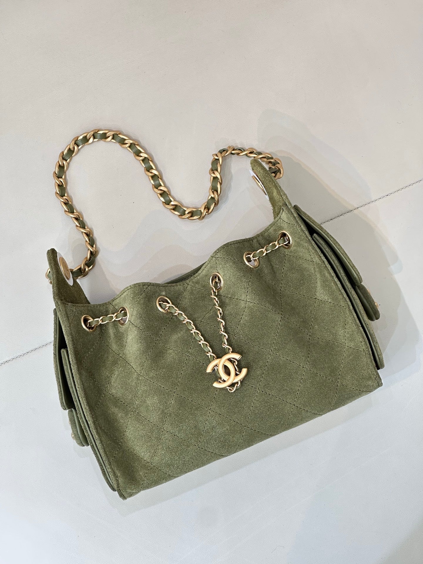 Chanel mini handbag in olive green with gold chain strap and front clasp closure