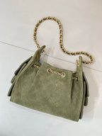 Chanel mini handbag in olive green with gold chain strap, side tabs, and front ring