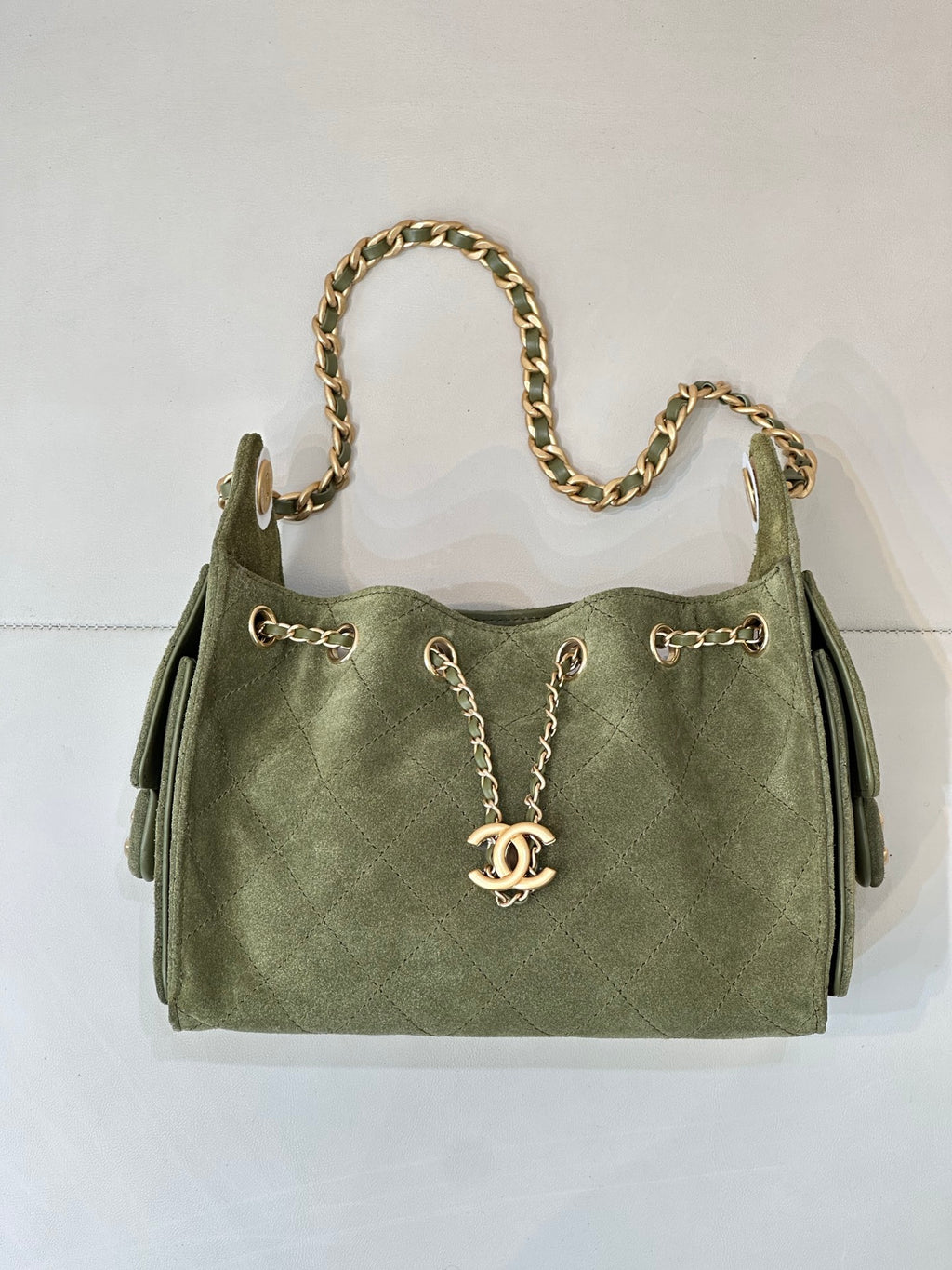 Chanel mini handbag in olive green with gold chain strap and two side tab pockets